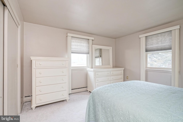 bedroom with a baseboard heating unit, a baseboard radiator, and light colored carpet