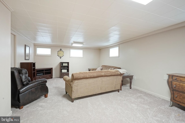 living area featuring light carpet and baseboards