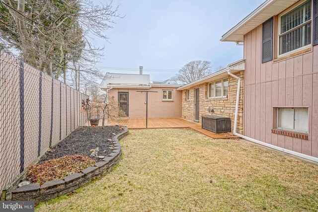 view of yard with a deck and a fenced backyard