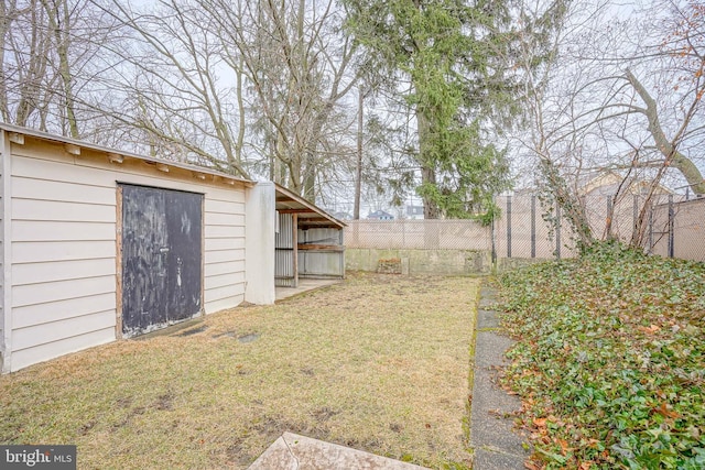 view of yard featuring an outdoor structure and fence