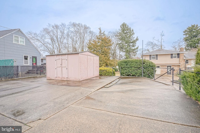 exterior space with a shed and fence