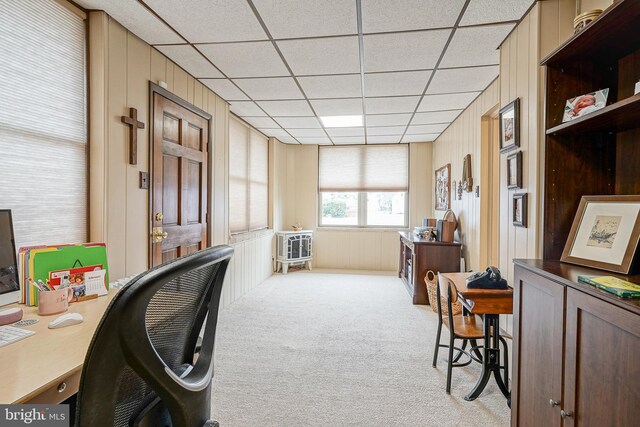 office with a paneled ceiling and light carpet