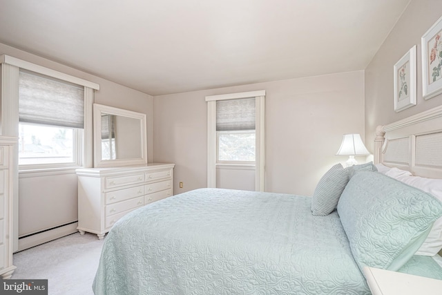 bedroom featuring light carpet and a baseboard radiator