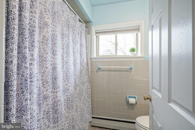 full bath with a baseboard heating unit and toilet