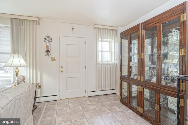 foyer featuring a baseboard radiator and light tile patterned flooring