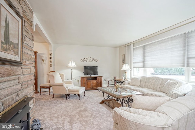 living area with light carpet, a baseboard radiator, and a wealth of natural light