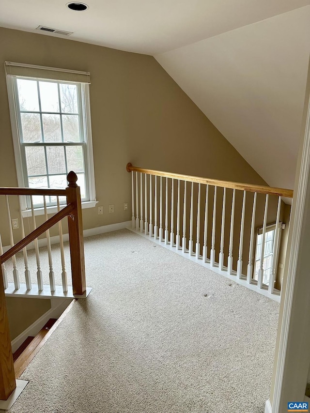 additional living space with lofted ceiling and carpet