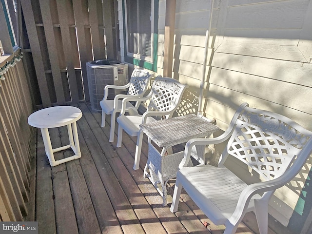 wooden deck featuring central AC unit