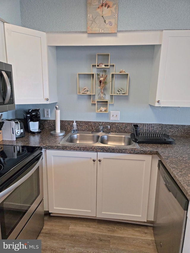 kitchen featuring white cabinetry, sink, and stainless steel appliances