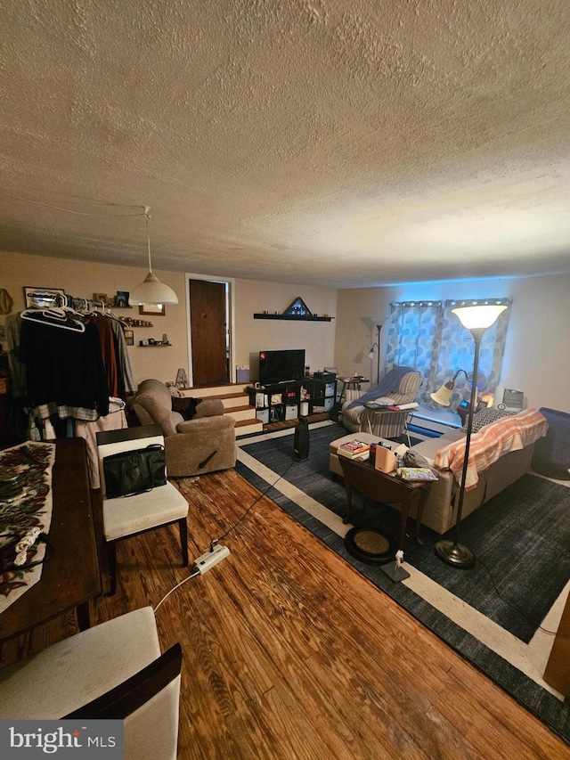 living room featuring hardwood / wood-style flooring and a textured ceiling