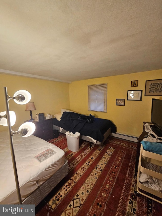 bedroom featuring a baseboard radiator and a textured ceiling