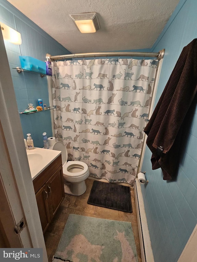 bathroom with vanity, curtained shower, a textured ceiling, and toilet