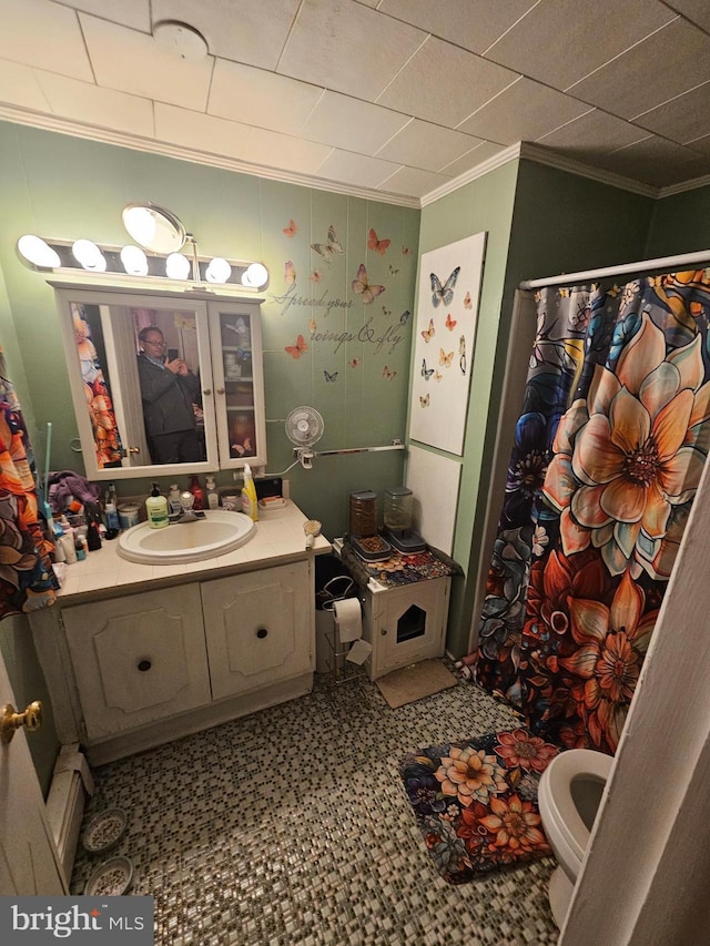 bathroom with ornamental molding, toilet, and vanity