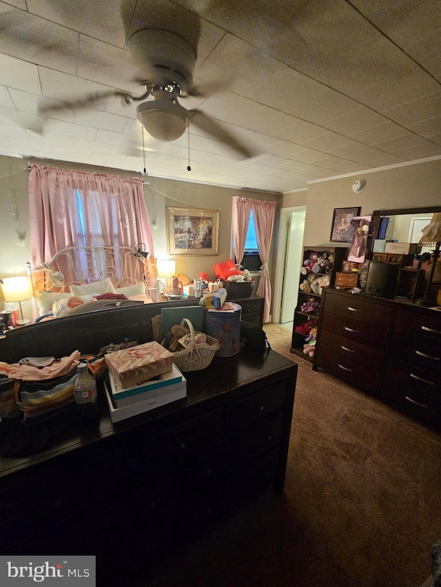 carpeted bedroom featuring crown molding and ceiling fan