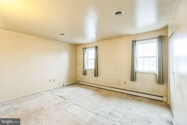 carpeted empty room featuring baseboard heating