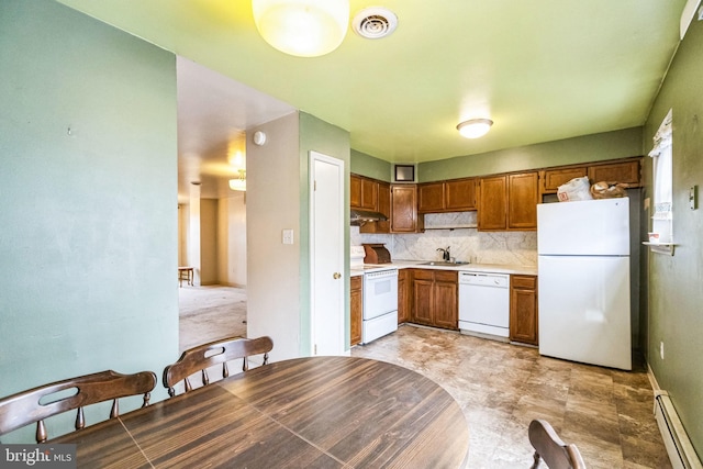 kitchen featuring a baseboard radiator, sink, white appliances, and decorative backsplash