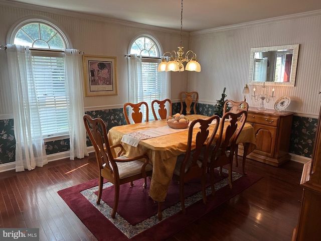 dining area with crown molding, dark hardwood / wood-style floors, and a notable chandelier