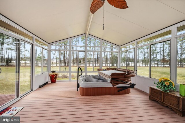 sunroom / solarium with a hot tub, vaulted ceiling with beams, and ceiling fan