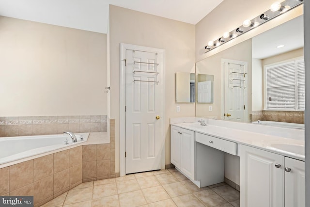 bathroom with vanity, tiled bath, and tile patterned floors