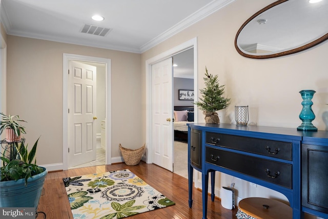 interior space featuring hardwood / wood-style floors and crown molding