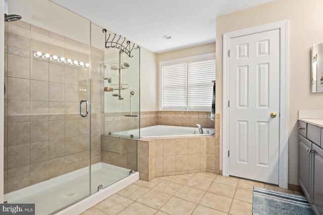 bathroom with tile patterned flooring, vanity, and shower with separate bathtub