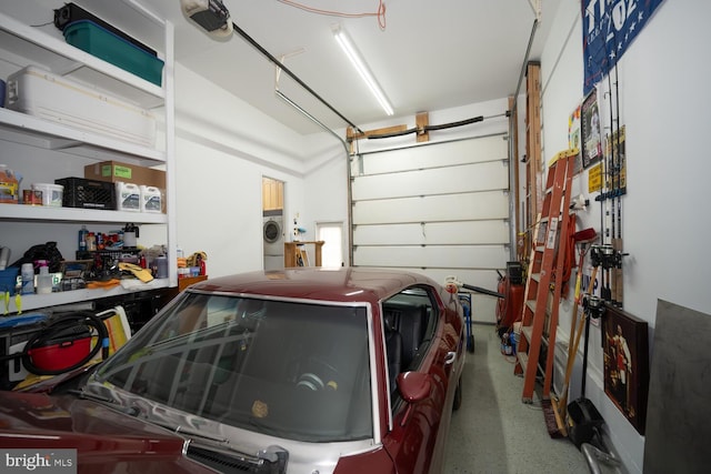 garage with a garage door opener and washer and clothes dryer