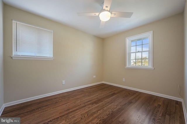 empty room featuring ceiling fan and dark hardwood / wood-style floors