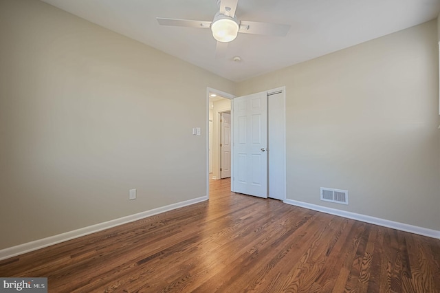 empty room with ceiling fan and wood-type flooring