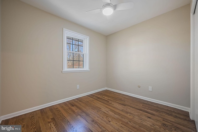 empty room featuring ceiling fan and dark hardwood / wood-style flooring