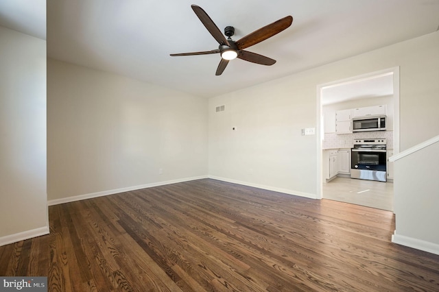 unfurnished room with hardwood / wood-style flooring and ceiling fan