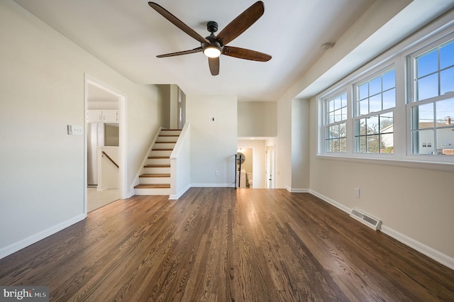 unfurnished living room with ceiling fan and dark hardwood / wood-style floors