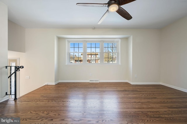 spare room featuring ceiling fan and dark hardwood / wood-style flooring