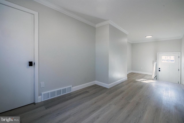 interior space featuring hardwood / wood-style floors and crown molding