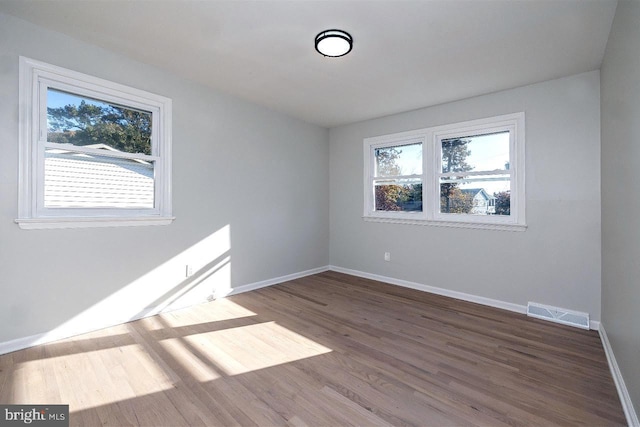 empty room with wood-type flooring