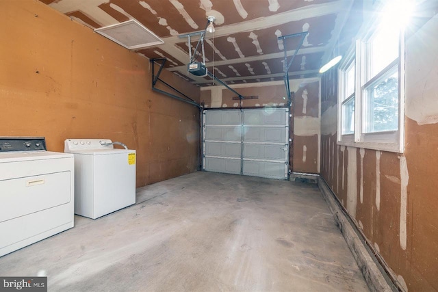 garage featuring a garage door opener and washer and dryer