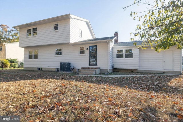 rear view of house with central AC