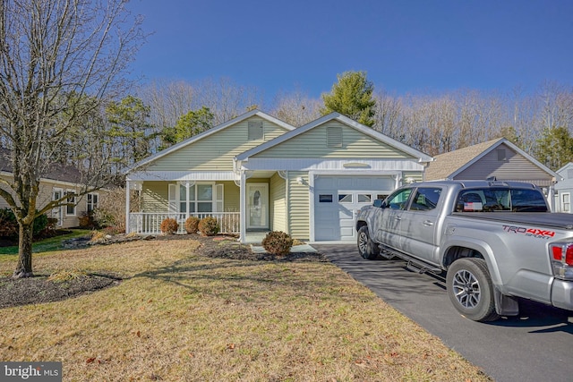 view of front of home with a porch, a garage, and a front lawn