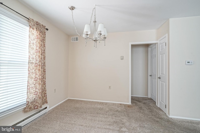 carpeted empty room with baseboard heating and a notable chandelier