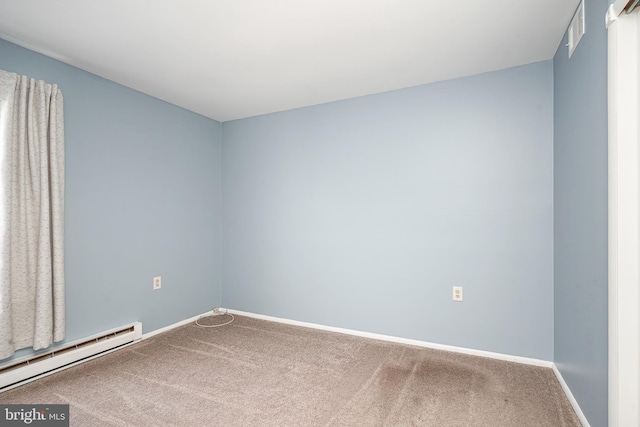 carpeted empty room with a baseboard radiator