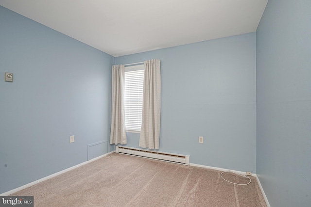 unfurnished room featuring a baseboard heating unit and carpet flooring