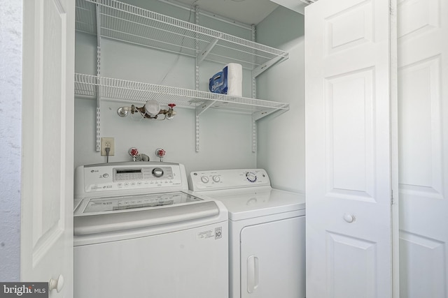 laundry area with washing machine and dryer