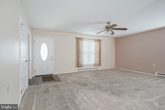 carpeted foyer entrance with a baseboard radiator, a wealth of natural light, and ceiling fan