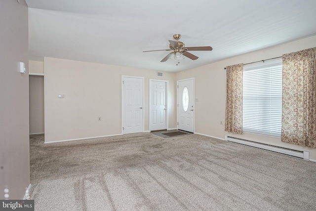 empty room featuring carpet, a baseboard heating unit, a wealth of natural light, and ceiling fan