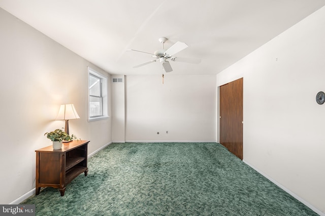 carpeted spare room featuring ceiling fan