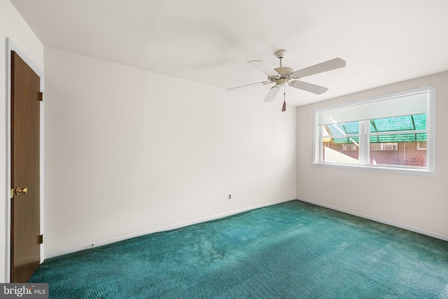 empty room featuring ceiling fan and carpet