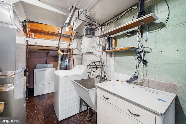 laundry area with separate washer and dryer and cabinets