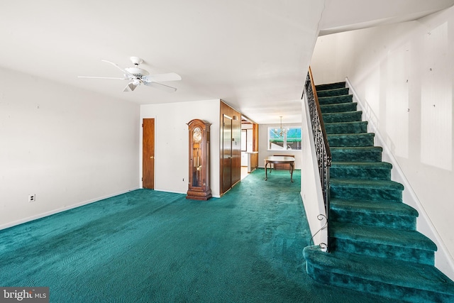 interior space featuring ceiling fan with notable chandelier and dark colored carpet