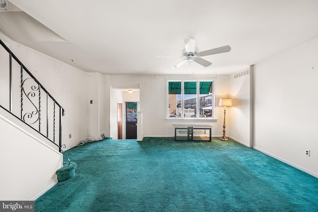 unfurnished living room featuring carpet floors and ceiling fan