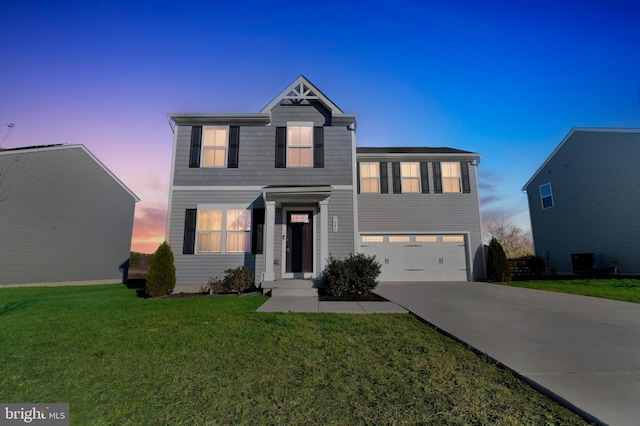 front of property featuring a garage and a lawn