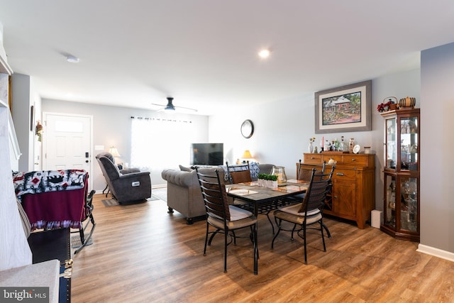 dining room with hardwood / wood-style flooring and ceiling fan